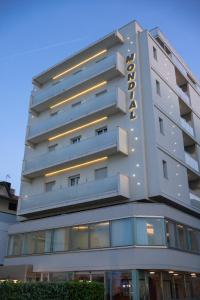 a tall building with a hotel sign on it at Mondial Beauty Suite in Bellaria-Igea Marina