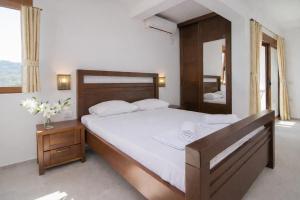 a bedroom with a large bed and a mirror at Arabela 2 Apartments in Utjeha +109 photos