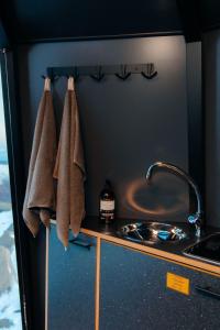 a kitchen with a sink and towels on a counter at Adventure Stay in Vík