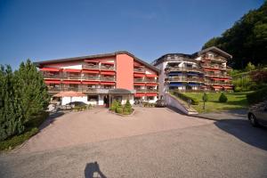a person standing in front of a building at Eden au Lac in Echternach