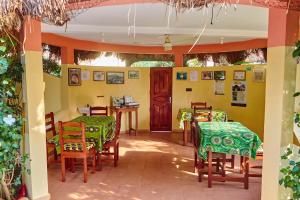 a restaurant with tables and chairs in a room at Chez Sabine in Abomey
