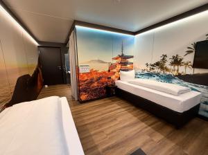 a room with two beds and a window with a picture at ILS Hotel by WMM Hotels in Ilsfeld