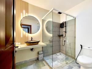 a bathroom with a sink and a toilet and a mirror at SkyVilla BKK - Pool & Chill - Laundry included in Phnom Penh