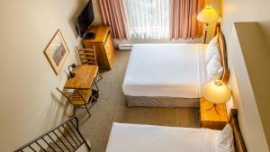 a small room with a bed and a desk and a bed sidx sidx sidx sidx at Cahilty #434 home in Sun Peaks