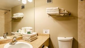 a bathroom with a sink and a toilet and a mirror at Cahilty #434 home in Sun Peaks +5 photos