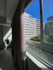 a window in a room with a view of a building at CityNest Hotel Apartment in Cape Town +2 photos