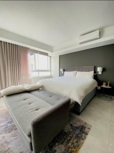 a bedroom with a large bed and a couch at CityNest Hotel Apartment in Cape Town