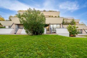 a house with a green lawn in front of it at Desenzano - 2' to Station & Lake - Pool, Wifi, AC in Desenzano del Garda