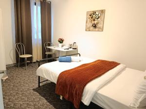 a hotel room with two beds and a table at Studio M in Timişoara +14 photos