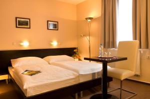 a bedroom with a bed and a table with a lamp at Franko hotel in Zvolen