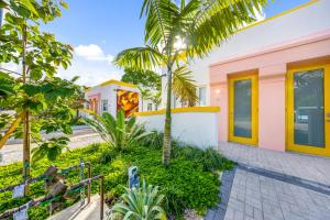 a house with a palm tree in front of it at El Jardin Inn in Miami
