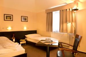 Posteľ alebo postele v izbe v ubytovaní Franko hotel