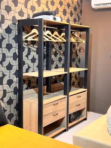 a black and wooden closet with shoes in it at Art studio DA in Salvador