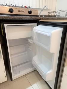 an empty refrigerator with its door open in a kitchen at Habitaciones amuebladas Veracruz Logos in Veracruz