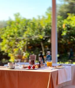 a table with plates of food and drinks on it at Tancat de Codorniu in Les Cases d'Alcanar