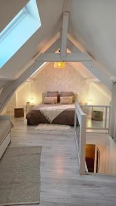 a bedroom with a bed in an attic at Le Royal Billy in Dreux