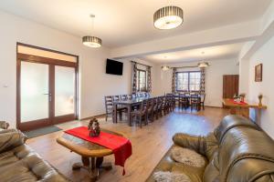 a living room with a couch and a table at Pensiunea Casa Brancovenilor in Sâmbăta de Sus