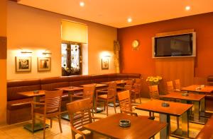 a restaurant with tables and chairs and a couch at Penzion Franko in Zvolen