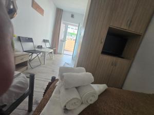 a pile of towels sitting on a bed in a room at VILA APROAPE DE MARE/ LA CASTEL in Costinesti