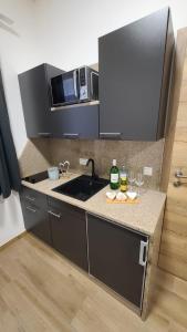 a kitchen with a sink and some bottles and glasses at BestFriends-Lenzing in Lenzing