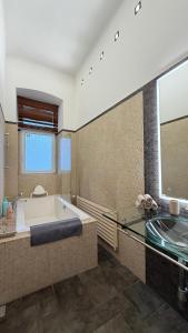 a large bathroom with a tub and a sink at Apartment Hviezdko - Heart of Old Town in Bratislava +22 photos
