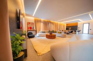 a large living room with white couches and a table at Villa Horizon in Marrakesh