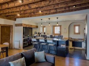 an open kitchen and living room with wooden ceilings at Cal 1777 in Bourg-Madame