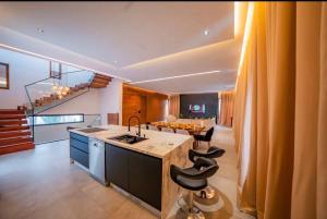 a kitchen with a island with a sink and a table at Villa Horizon in Marrakesh