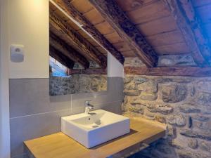 a bathroom with a sink and a stone wall at Cal 1777 in Bourg-Madame +72 photos