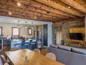 a living room with a table and a bar at Cal 1777 in Bourg-Madame