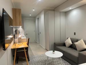 a living room with a couch and a table at Executive Studio at Ellipse Galileo - Waterfall in Midrand