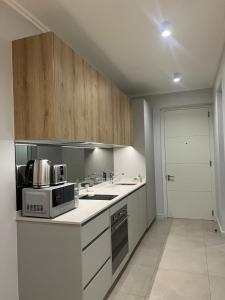 a kitchen with a microwave oven and a stove at Executive Studio at Ellipse Galileo - Waterfall in Midrand