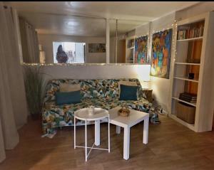 a living room with a couch and a table at Le Nid in Avignon