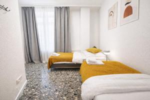 a room with two beds and a window at Representative City Villa in Meerbusch