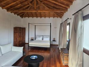 a living room with a bed and a couch at Paralies Resort in Skiathos