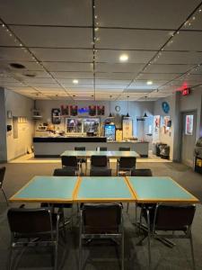 a large room with tables and chairs in it at Minnedosa Inn in Minnedosa
