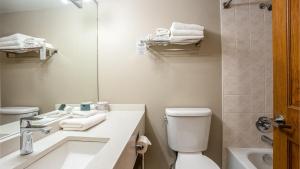 a bathroom with a sink and a toilet and a mirror at Cahilty #265 in Sun Peaks