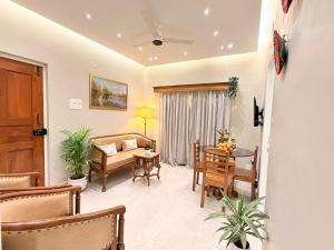 a living room with a couch and a table at MILANO By The Beach Goa in Benaulim