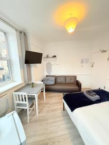 a living room with a couch and a table at Wandsworth Guest Rooms 64 in London