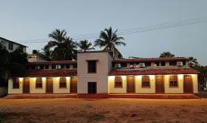 an old house with lights on the side of it at Jamath Villas 1307 in Kīlakarai