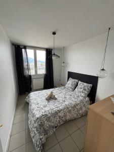 a bedroom with a bed with a teddy bear on it at Le 305 Beauvert Parking Gratuit in Grenoble