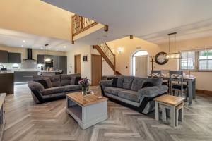 a living room with two couches and a kitchen at 2 Bed in Brampton oc-c34637 in Brampton