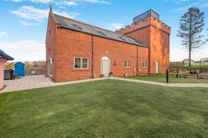 an old brick building with a grass yard at 2 Bed in Brampton oc-c34637 in Brampton
