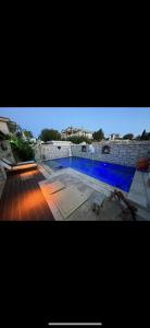 a picture of a swimming pool with blue water at Eos in Çeşme