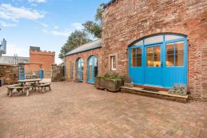 a brick building with a blue door and a picnic table at 3 Bed in Brampton oc-g34639 in Brampton
