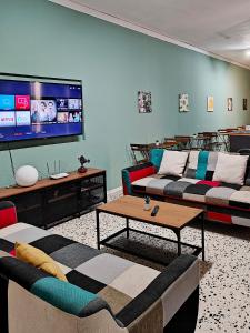 a living room with two couches and a flat screen tv at Cosyroom 3 in Pieta