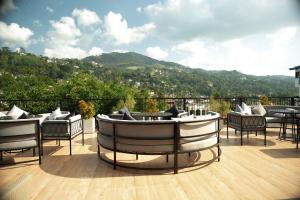 a patio with chairs and a boat on a deck at Orbit88 Hotel by AMR in Kandy