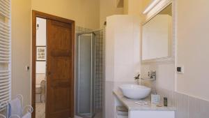 a bathroom with a sink and a mirror at Tenuta Olive Alive in Noto