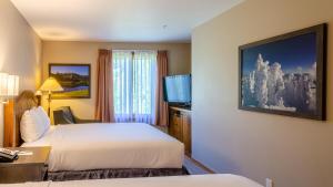 a hotel room with two beds and a television at Cahilty #313 home in Sun Peaks