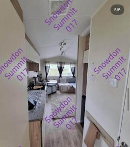 a living room with purple writing on the ceiling at Snowdon Summit 017 in Barmouth +1 photo